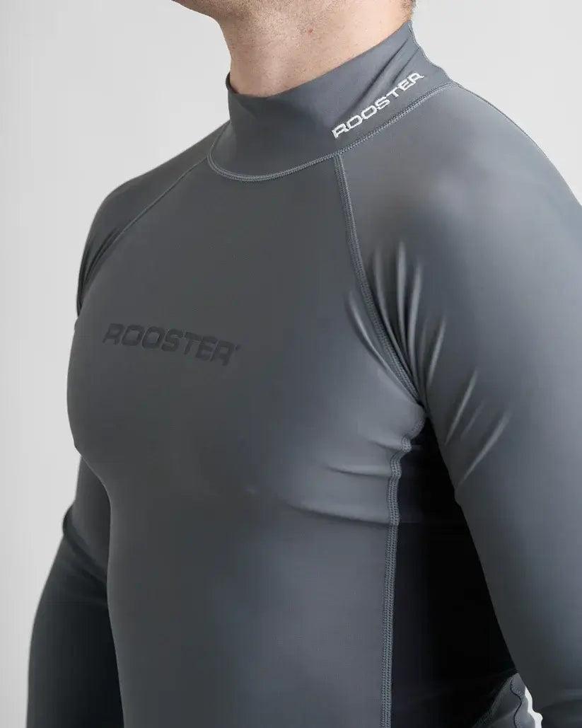 Rash Top-Long Sleeved de Rooster en lycra spandex, conçu pour protection anti-UV et activités nautiques.