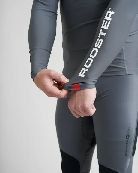 Rash Top-Long Sleeved de Rooster, haut technique anti-UV avec logo Rooster et empiècements en lycra spandex.