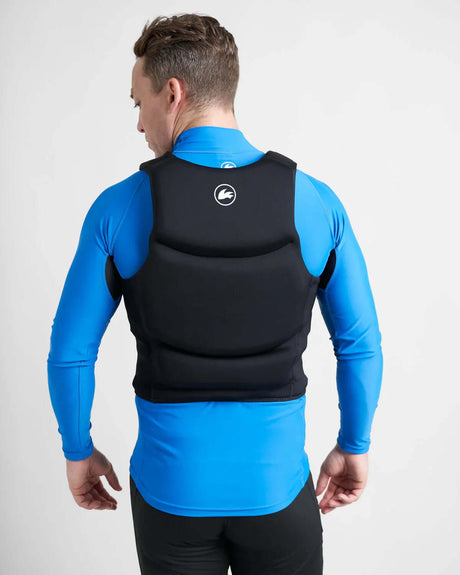 Gilet de sauvetage compact régate, vue arrière sur un homme portant un gilet néoprène et une combinaison de surf.