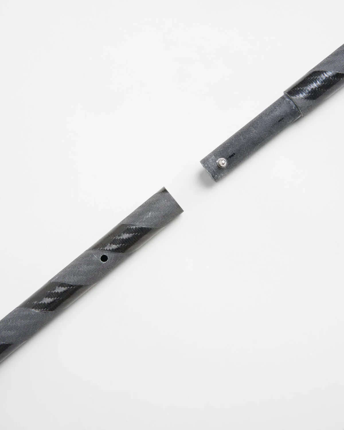 ILCA Travel carbon Tiller Extension 1250 close-up showing carbon fiber construction and connection detail.