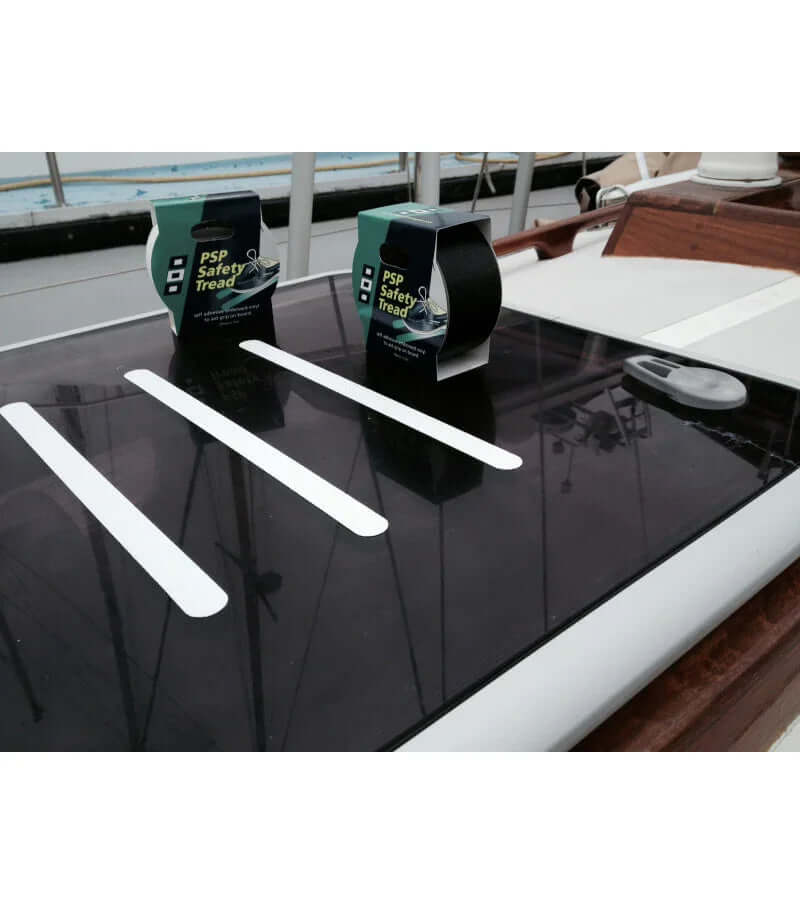 Kit bandes anti-dérapantes - Par 10 avec bandes blanches sur une surface de bateau.