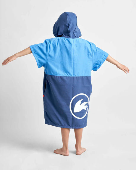 Poncho Junior microfibres porté par un enfant, vue arrière, couleur bleu et bleu marine, conçu pour le confort après les activités nautiques.