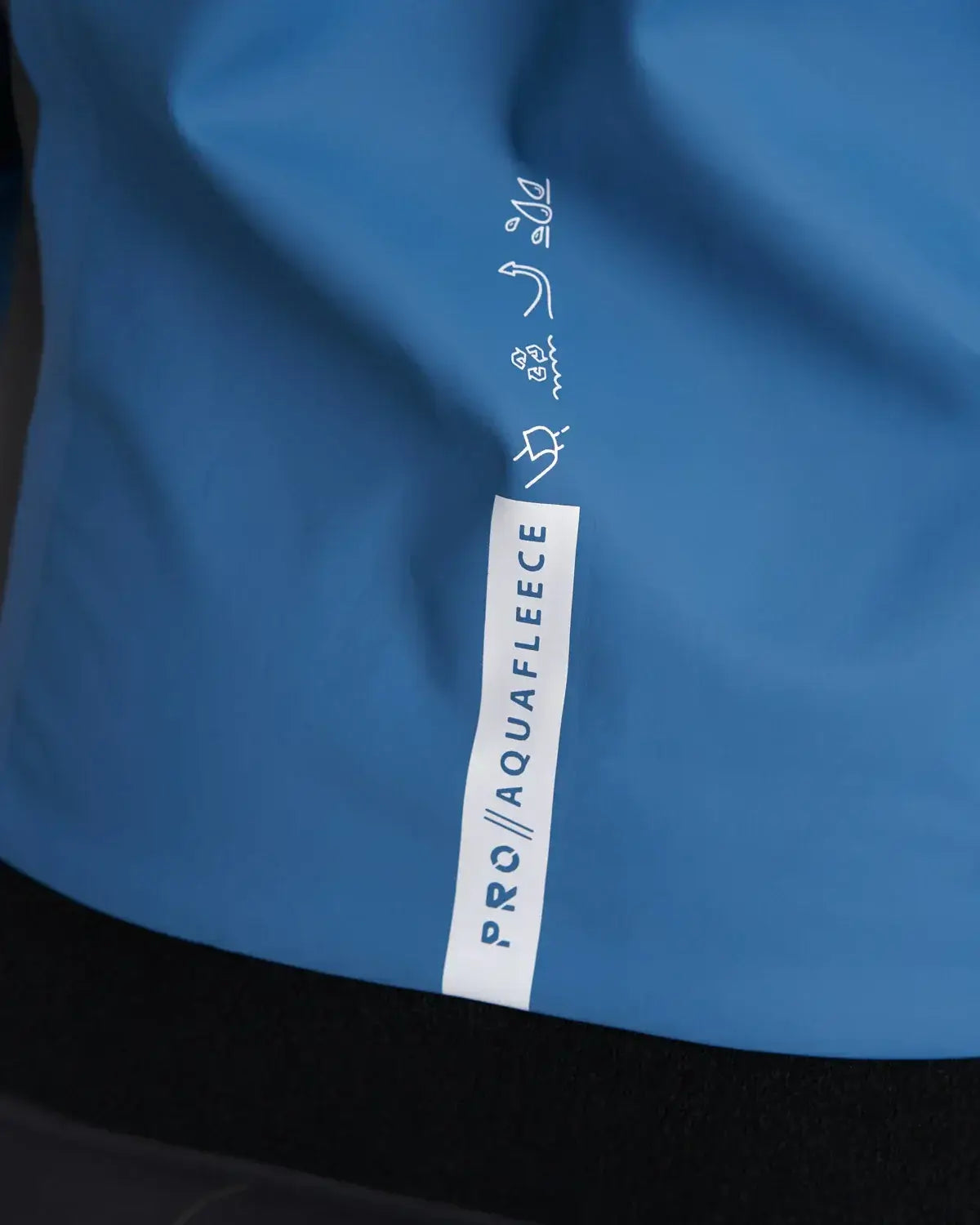 Top Pro Aquafleece Women showing the waterproof fabric and branding details in blue.